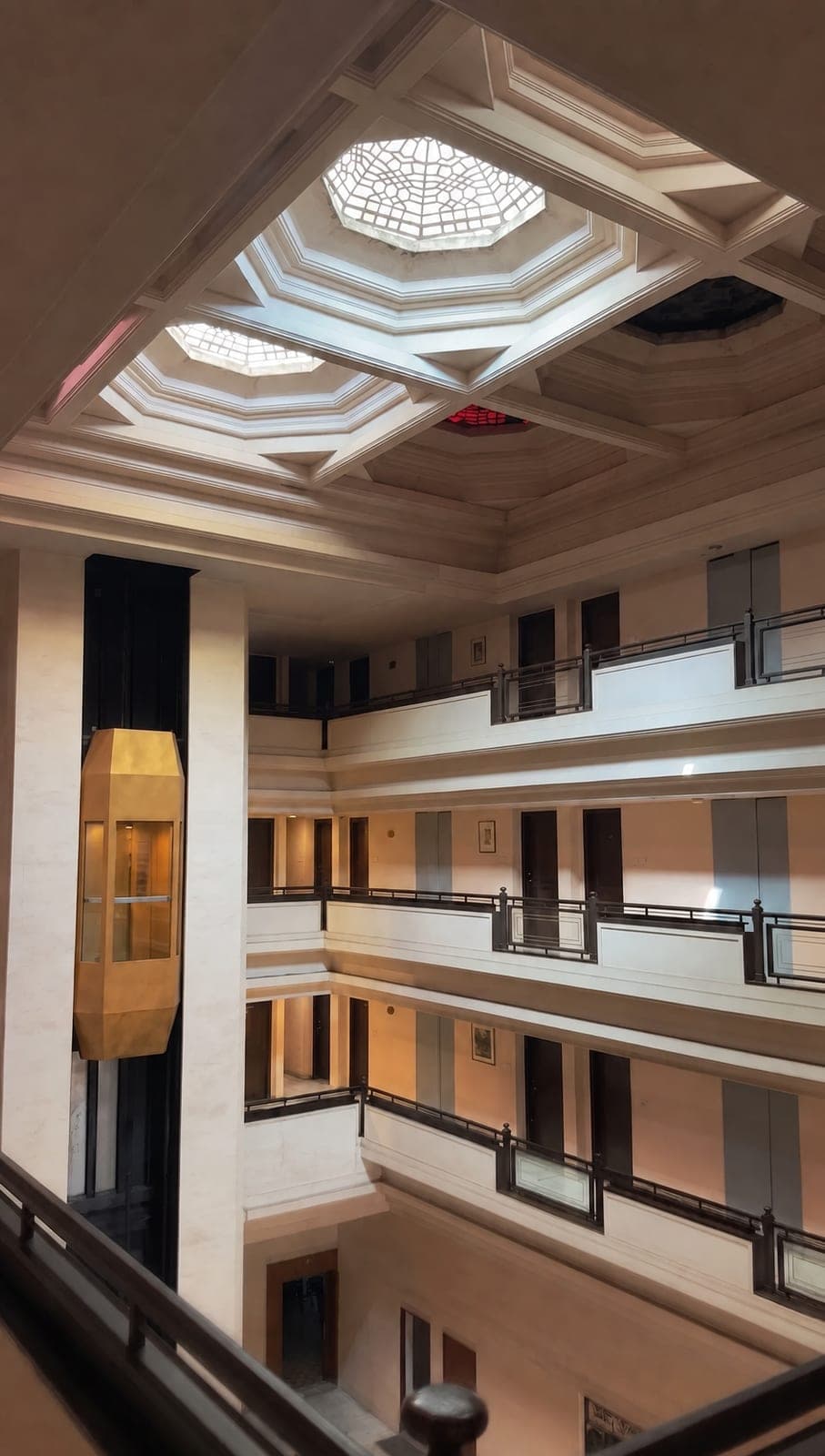 Atrium with the brass lift and lattice skylight