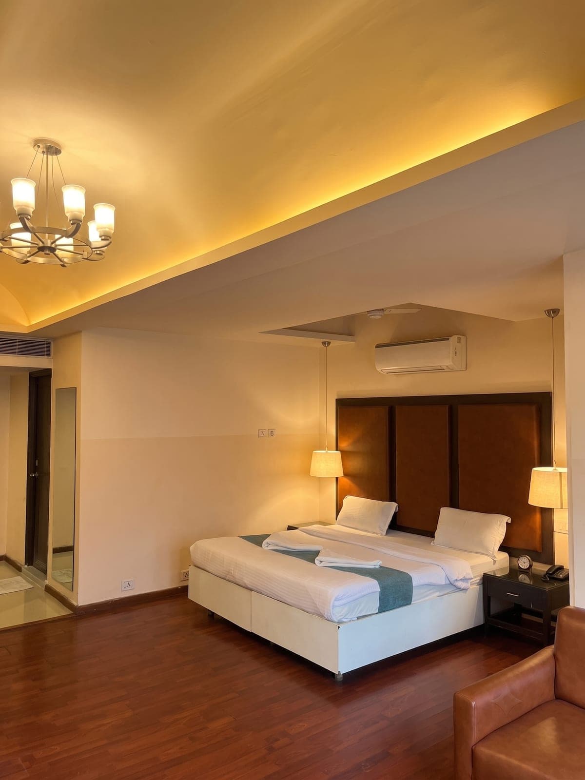 Suite with a king bed and warm cove lighting